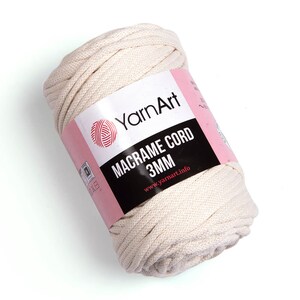 May include: A roll of natural colored macrame cord with a label that reads 'YarnArt Macrame Cord 3MM www.yarnart.info'
