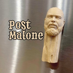 May include: A beige 3D printed bust of Post Malone, with a detailed face and beard. The bust is on a silver background.