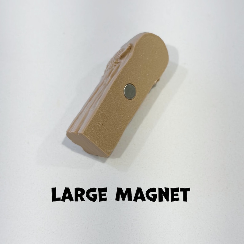 May include: A large, brown, rectangular magnet with a textured surface. The magnet has a silver metal backing.