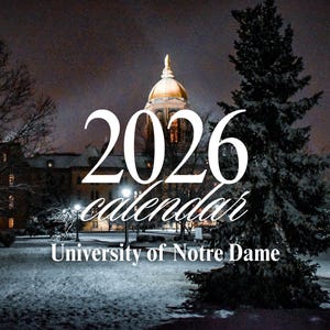 May include: A nighttime winter scene featuring the University of Notre Dame. The image displays the text "2026 calendar" in a stylized font, with the university's name below. The golden dome is illuminated against a dark sky.
