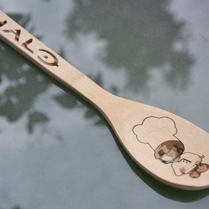 May include: A wooden spoon with the word "HALO" and a cartoon chef engraved on it.