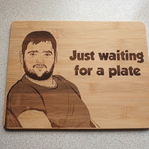 May include: A wooden cutting board with a laser-engraved image of a person and the text "Just waiting for a plate".