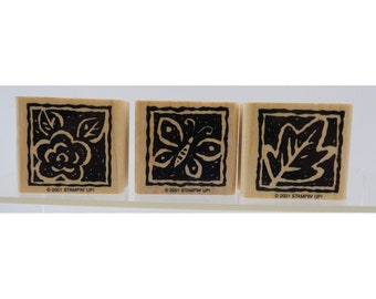 Peut inclure: Trois tampons en bois avec des motifs d'encre noire. Les motifs sont une rose, un papillon et une feuille. Chaque tampon a une bordure noire et le texte "©2001 STAMPIN' UP!" en bas.