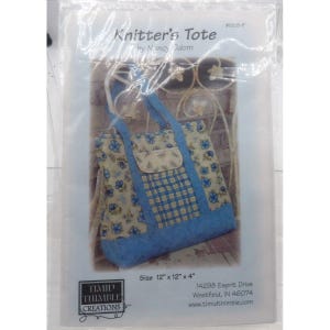 May include: A blue and white floral tote bag with a checkered pocket. The bag is 12 inches by 12 inches by 4 inches. The pattern is called "Knitter's Tote" by Nancy Odom.