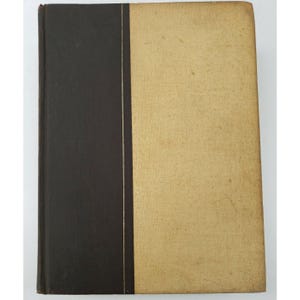 May include: A brown hardback book with a gold spine and a tan cover.