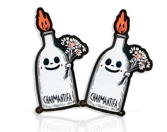 May include: Two black and white stickers of a ghost holding a bouquet of flowers. The ghost is in a bottle with a flame on top. The text "CHARMANTIFA" is on the bottle.