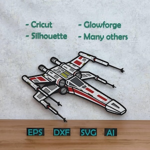 May include: A detailed, multi-layered X-wing starfighter design in red, white, black, and grey. The image includes the words "- Cricut - Silhouette - Glowforge - Many others" and the file type abbreviations "EPS, DXF, SVG, AI".