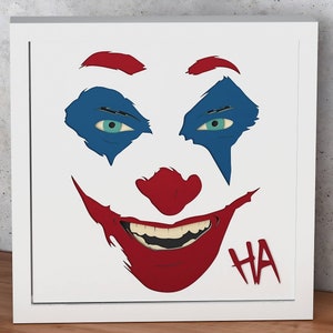 May include: A white background with a red, blue, and black illustration of a Joker's face. The Joker's eyes are blue and the mouth is open in a wide smile. The text "HA" is written in red below the mouth.