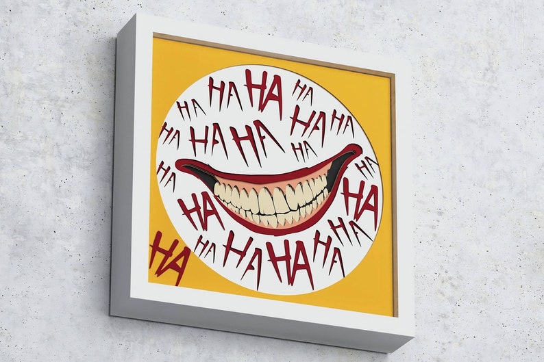 May include: A framed print with a yellow background and a white circle containing a red and white grinning mouth with the word "HA" repeated around the circle.