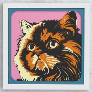 May include: A close-up of a cat's face with orange, black, and white fur. The cat has large, green eyes and a pink nose. The cat is looking directly at the viewer.
