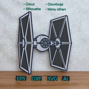 May include: A grey and black TIE fighter model with the text "- Cricut - Silhouette - Glowforge - Many others". The model includes the file formats EPS, DXF, SVG, and AI.