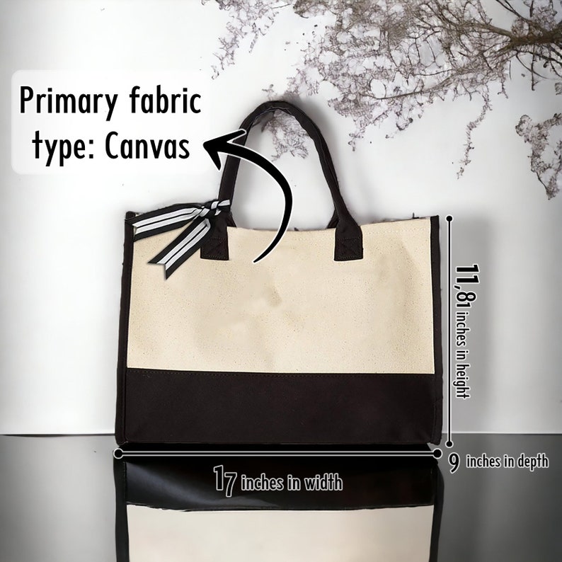 May include: A large canvas tote bag with black trim and a black bottom. The bag is 11.81 inches high, 17 inches wide, and 9 inches deep. The bag has a black and white striped ribbon on the top.