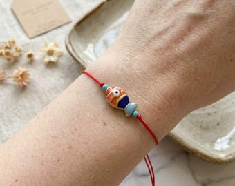 Lucky Fish Red String Bracelet: Reversible Enamel & Gold Charm