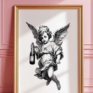 Könnte beinhalten: Schwarz-Weiß-Druck eines Engels mit einer Champagnerflasche in einem Rahmen. Der Engel hat detaillierte Flügel und trägt fließende Gewänder. Der Druck befindet sich in einem goldenen Rahmen, der an einer rosa Wand lehnt.