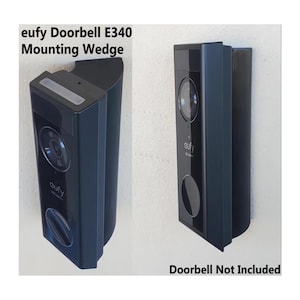 May include: A black Eufy Doorbell E340 mounting wedge shown from two angles. The device is a rectangular, angled plastic mount designed to hold a security doorbell. Text on the image reads: eufy Doorbell E340 Mounting Wedge and Doorbell Not Included.