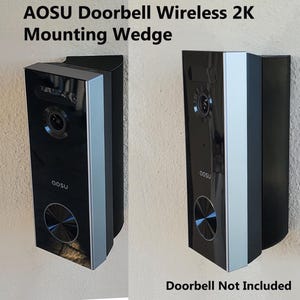 May include: A black and silver doorbell mounting wedge. The wedge is designed to help mount a doorbell on a surface that is not level. The text "Doorbell Not Included" is printed below the wedge.