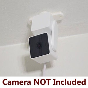 May include: White ceiling mount for a security camera. The mount is adjustable and can be rotated to point the camera in different directions. Camera NOT Included.