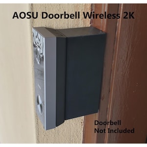 May include: A black and silver doorbell camera mounted on a wall. The text "Doorbell Not Included" is written below the camera.