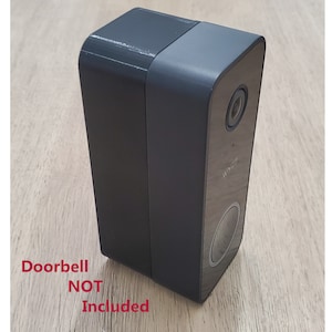 May include: Black doorbell camera housing with a round button and a lens. Doorbell NOT Included.