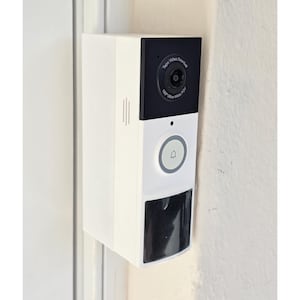 May include: A white and black video doorbell mounted on a wall. The doorbell has a camera, a button with a bell icon, and the text "Tapo Video Doorbell" and "160° Ultra-Wide POV".