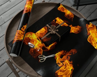 May include: Black wrapping paper with a repeating pattern of orange flames. A brown gift box with a brown ribbon is on top of the wrapping paper. A roll of wrapping paper with the same flame pattern is on the side.