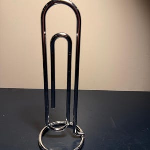 May include: A set of three ceramic mugs with a speckled, matte finish. The mugs are in shades of cream, light gray, and dark gray. Each mug has a simple, minimalist design, perfect for coffee or tea.