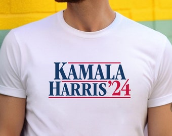 May include: A white t-shirt with the text "KAMALA HARRIS'24" printed in blue and red letters.