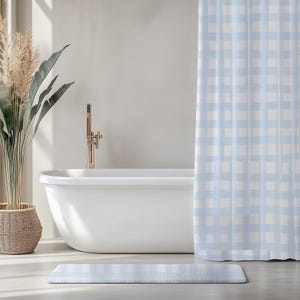 May include: A light blue and white gingham patterned shower curtain and a matching rectangular bath mat. The shower curtain features a classic checkered design, while the bath mat mirrors the same soft blue and white colour scheme.