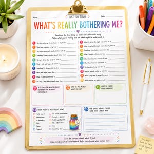 May include: A white paper worksheet titled What's Really Bothering Me? held on a gold clipboard. The document features twenty-five numbered prompts, colorful text, and a small illustration of a rainbow-colored jar with a tag labeled I matter.