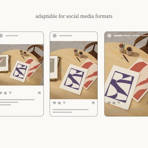 May include: Three abstract art prints with purple, red, and white geometric shapes on a wooden table. The prints are on a light wood table with a pencil and a cup of pencils.