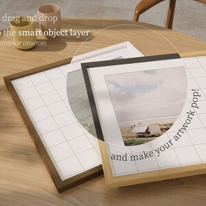 May include: Three picture frames on a wooden table. The frames are made of wood and have a white mat. The frame on the right has a photo of a beach scene with the text "and make your artwork pop!" printed on the frame.