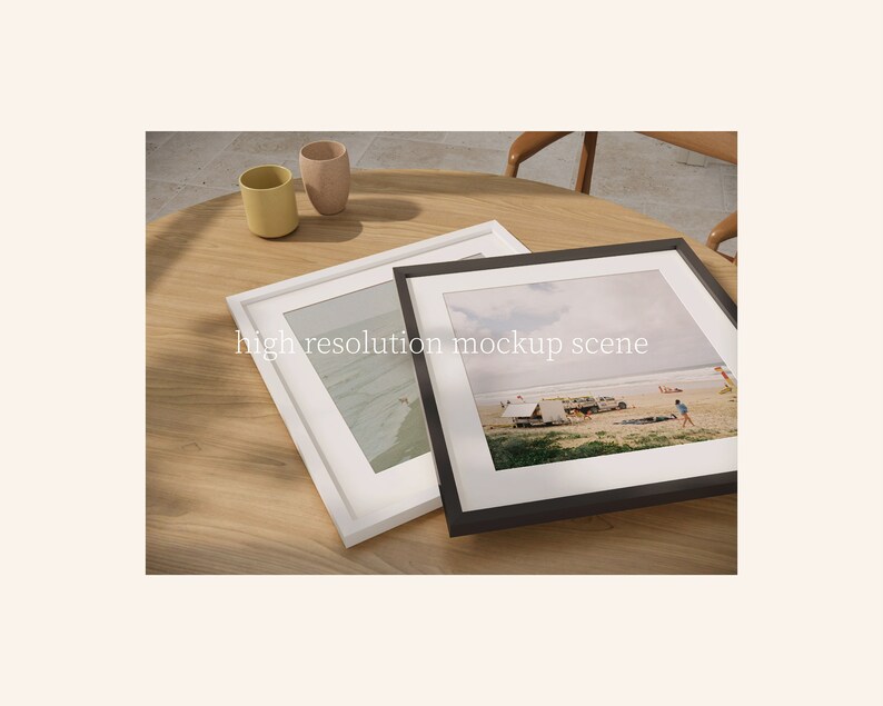 May include: Two framed photographs on a wooden table. The photo on the left shows a beach scene with waves crashing on the shore. The photo on the right shows a beach scene with people and tents. The photos are in white and black frames.