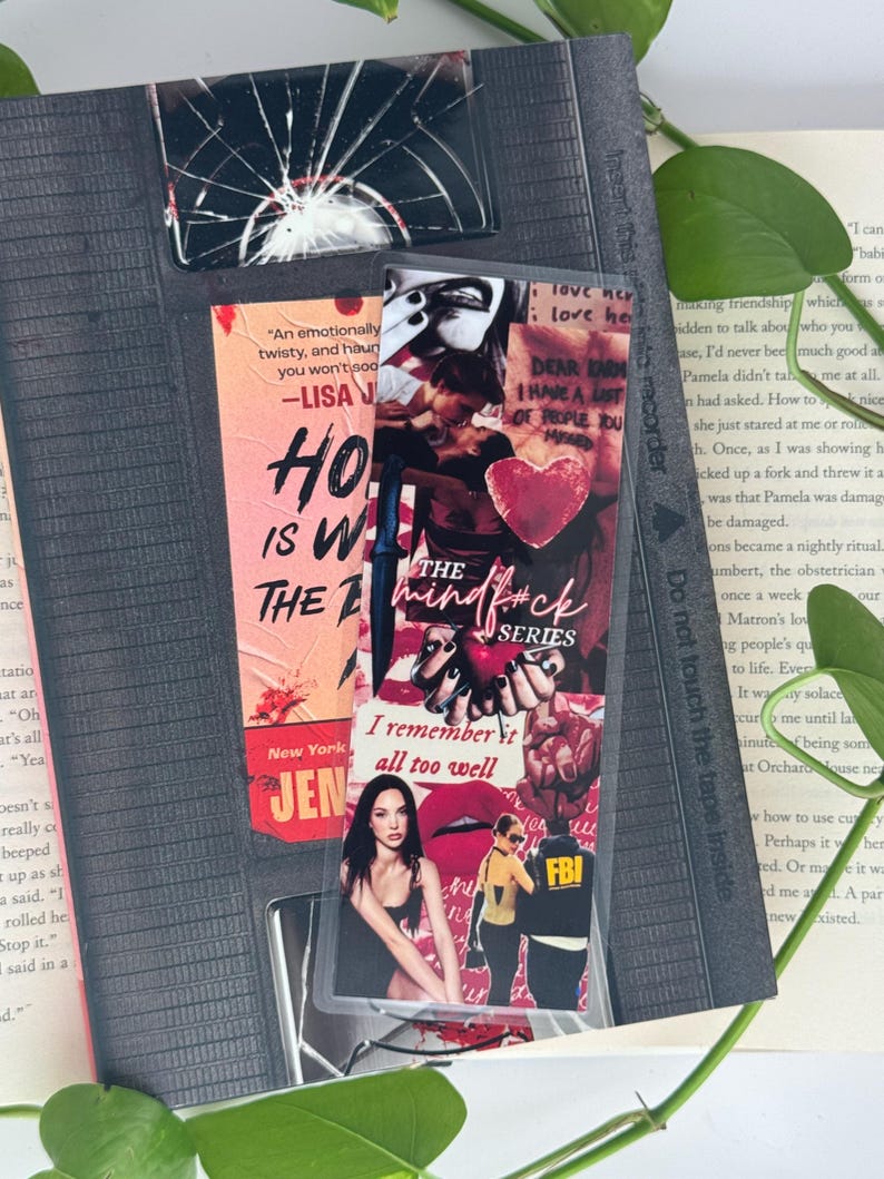 May include: A collection of bookmarks and a book. The bookmarks feature text and images, including a broken glass design, a quote, and a collage with the words "The Mindf*ck Series." The book is open, with text visible.