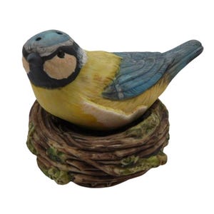 May include: A set of three ceramic mugs with a speckled, matte finish. The mugs are in shades of cream, light gray, and dark gray. Each mug has a simple, minimalist design, perfect for coffee or tea.