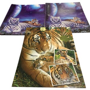 May include: Three rectangular folders featuring tiger imagery. Two top folders display white tigers against a purple cosmic background. The bottom folder shows a large orange tiger with two cubs, plus two inset photos of tiger cubs in nature.