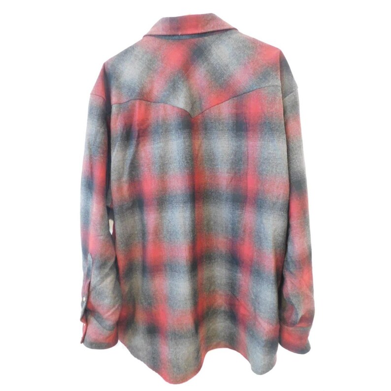 May include: A long-sleeve button-up shirt featuring a red, grey, and black plaid pattern. The shirt has a pointed collar, a western-style back yoke, and long sleeves with buttoned cuffs. The fabric has a soft, brushed texture throughout the garment.