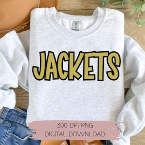 May include: A gray sweatshirt with the word "JACKETS" in large, bold, yellow letters with black outlines. The sweatshirt is folded and displayed on a wooden surface.