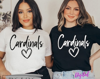 May include: Two women wearing t-shirts with the text "Cardinals" and a heart design. The shirts are white and black. The text is in black on the white shirt and white on the black shirt.