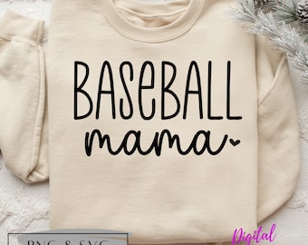 Könnte beinhalten: Ein beiger Pullover mit dem Schriftzug "BASEBALL mama" in schwarzer Schrift. Der Text ist in handschriftlicher Form mit einem kleinen Herz nach dem Wort "mama".