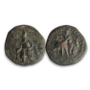 May include: Two antique bronze coins. One coin features a standing figure with a staff, surrounded by text. The other coin depicts a horse and figures. Both coins have a weathered, aged appearance.