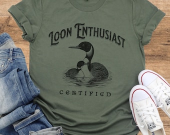 May include: A green t-shirt with a black loon graphic and the text "Loon Enthusiast Certified".