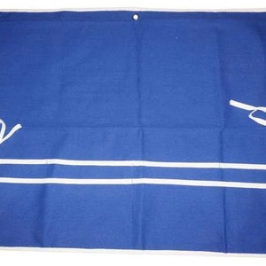 May include: A blue canvas tool roll with white trim and two white straps. The roll has three pockets.
