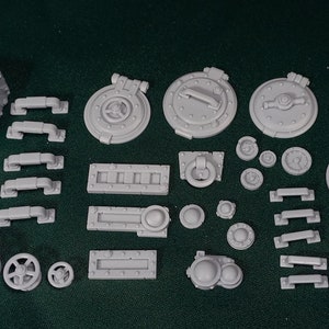 May include: A set of 20 gray plastic model pieces for steampunk or industrial themed miniature gaming. The pieces include various doors, handles, gears, and other details.