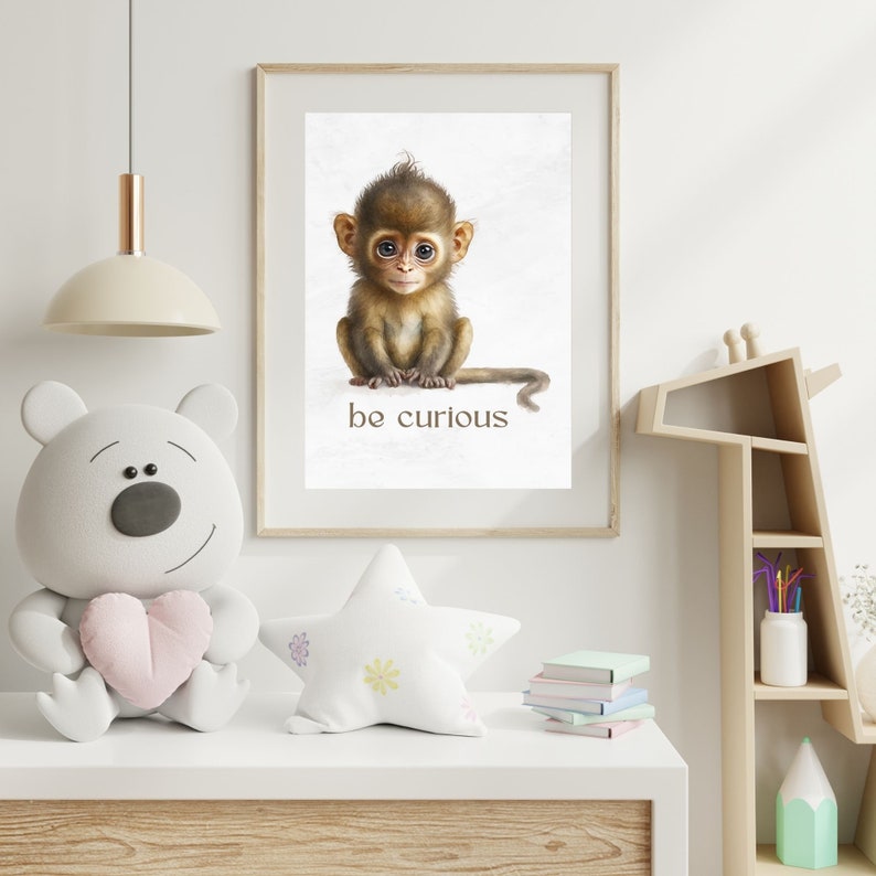 May include: A framed print of a cute baby monkey sitting with its tail curled around its legs. The print has a white background and the text "be curious" is printed below the monkey.