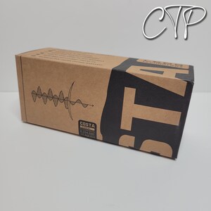 May include: A rectangular cardboard box with a brown and black color scheme. The box features the brand name "COSTA" in large, bold letters. The box also has a graphic of a sound wave and the text "U.S. PATENTS 6,334,680 & 6,604,824".
