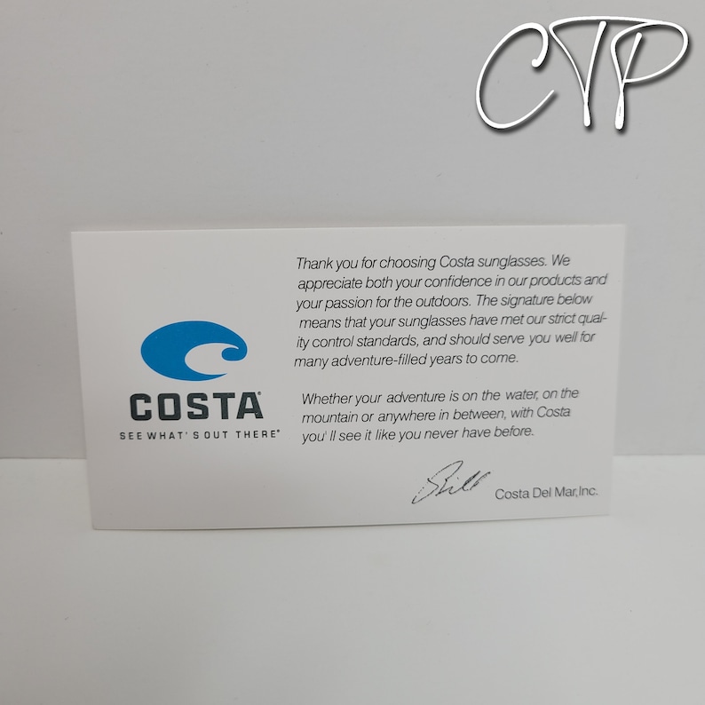 May include: A white card with the Costa Sunglasses logo, featuring a blue wave design and the text "COSTA SEE WHAT'S OUT THERE." The card includes text thanking customers and a signature.