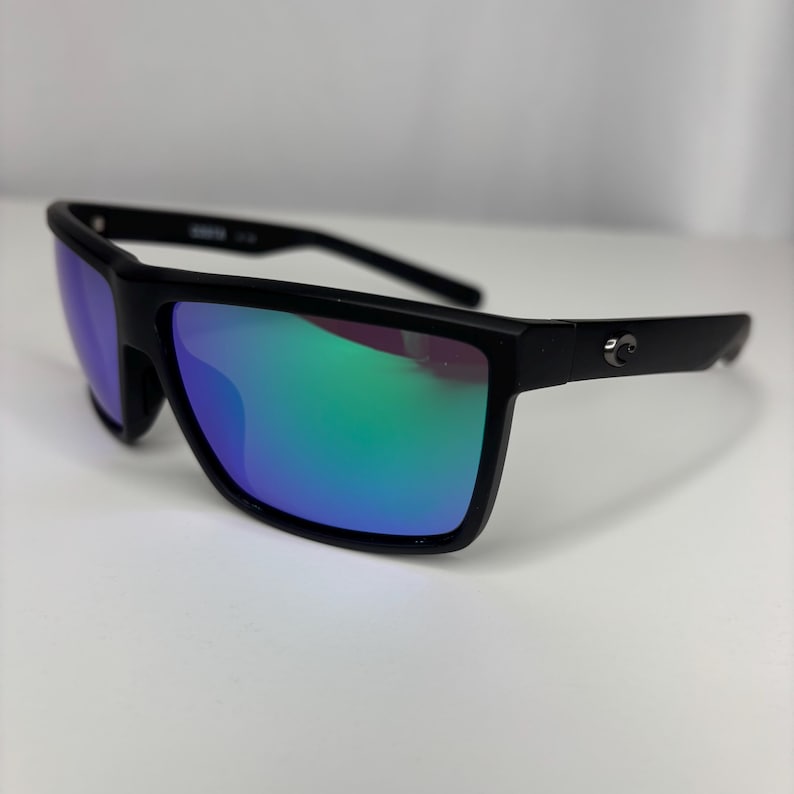 May include: Black sunglasses with a rectangular frame and mirrored lenses that reflect shades of blue and green. The sunglasses have a sleek, modern design, suitable for outdoor activities.