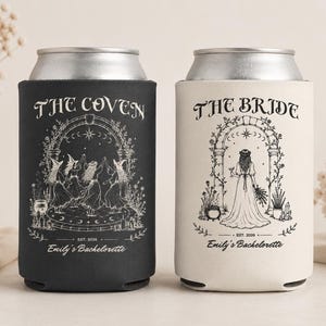 May include: Two foam can coolers, one black and one white, featuring silver metal rims. The black cooler displays the text THE COVEN above a group of witches, while the white cooler shows THE BRIDE above a figure in a gown. Both include EST. 2026 and Emily's Bachelorette.