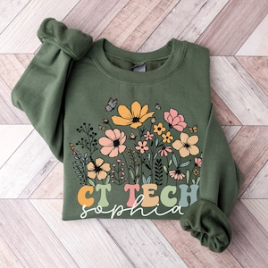 May include: A green sweatshirt with a floral design and the text "CT Tech Sophia" in colorful letters.