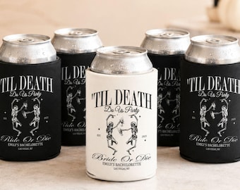 May include: Five cylindrical beverage can coolers in black and white, each featuring a graphic of two skeletons toasting with drinks. The text reads 'TIL DEATH Do Us Party', 'Ride Or Die', 'EMILY'S BACHELORETTE', and 'LAS VEGAS, NV' with the year 2023.